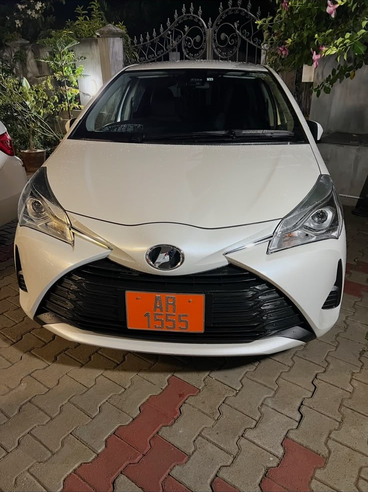 White IQ Driving School training car photographed at night